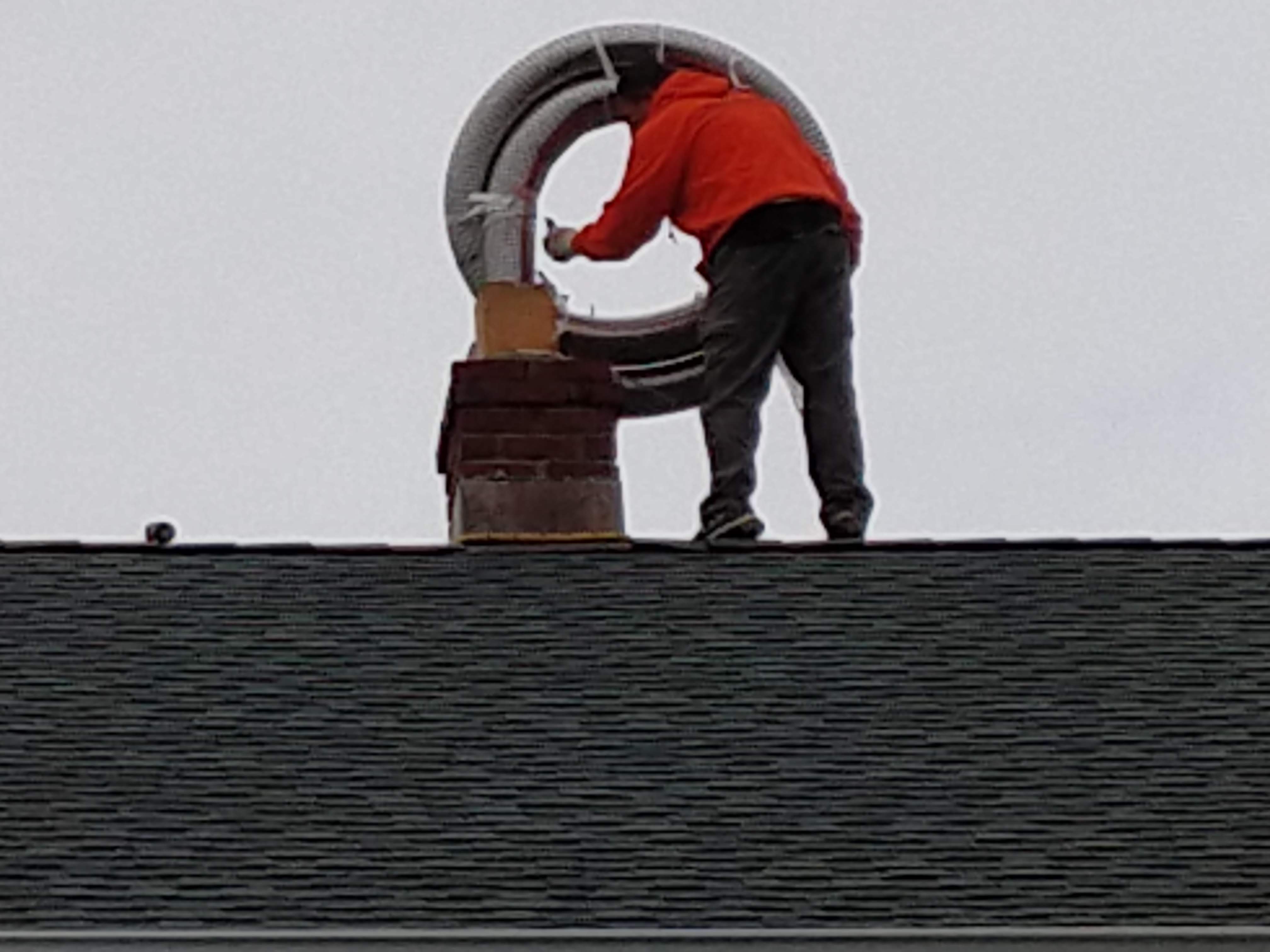 Flexible stainless chimney liner being installed in North Bellmore, New York